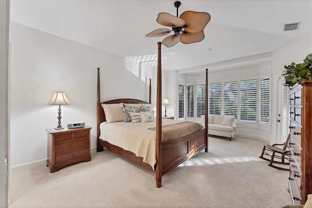 carpeted bedroom with a ceiling fan, visible vents, and baseboards