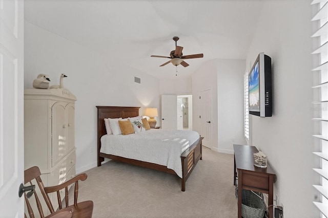 bedroom with light carpet, ceiling fan, visible vents, and baseboards