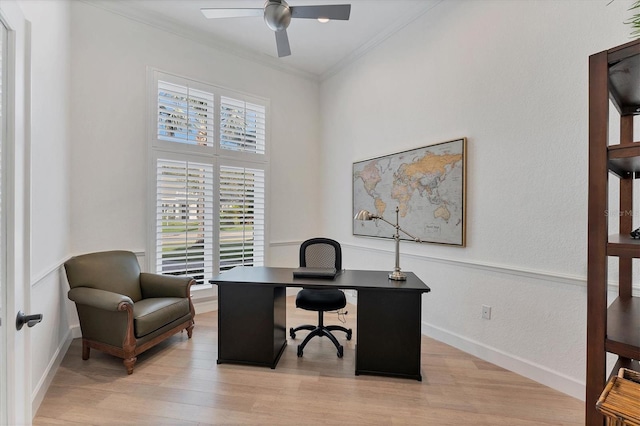 office area with ornamental molding, light wood-type flooring, baseboards, and a ceiling fan