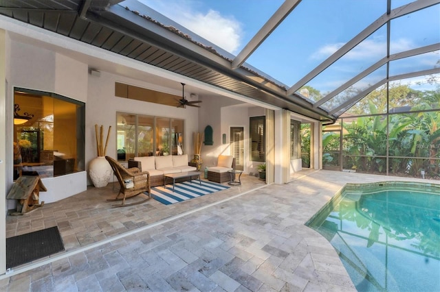 pool with a patio area, glass enclosure, an outdoor hangout area, and a ceiling fan