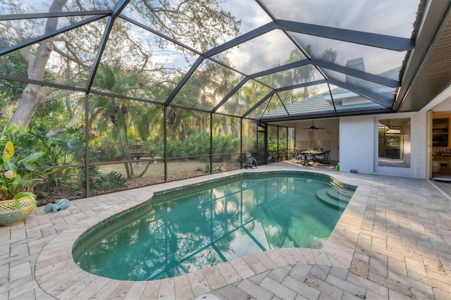 outdoor pool with a lanai and a patio area