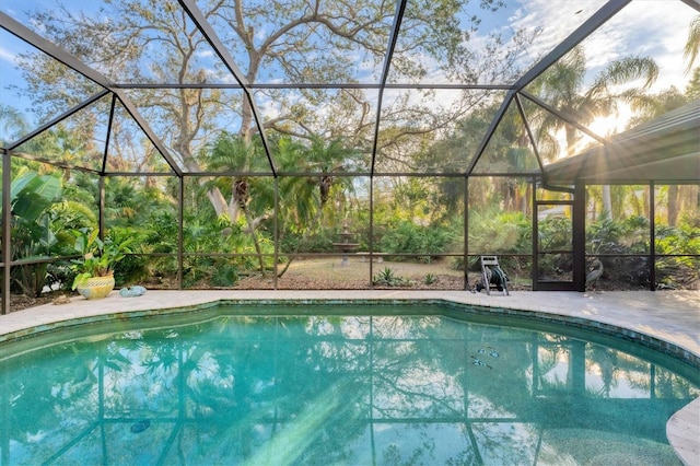 pool with glass enclosure and a patio