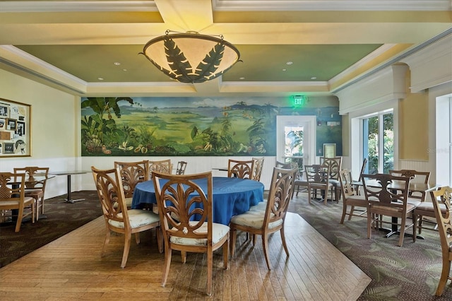 dining area featuring a tray ceiling, wainscoting, and crown molding