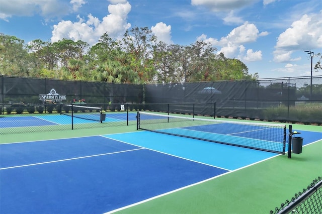 view of tennis court featuring fence