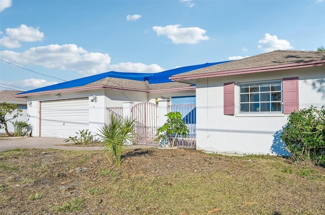 view of front of home with a garage and a front lawn