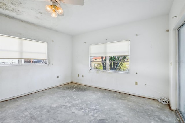 spare room featuring concrete floors and ceiling fan