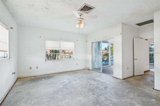 empty room featuring concrete floors and ceiling fan