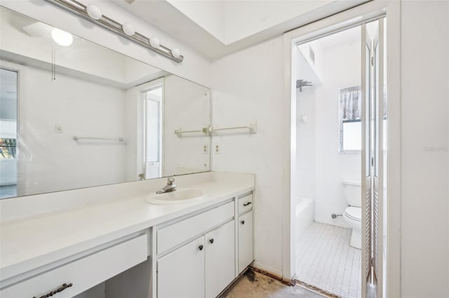 bathroom featuring a healthy amount of sunlight, vanity, and toilet