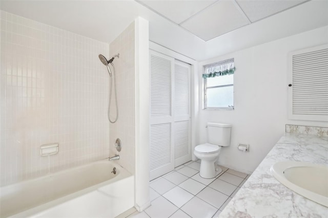 full bathroom featuring vanity, tiled shower / bath, tile patterned floors, and toilet