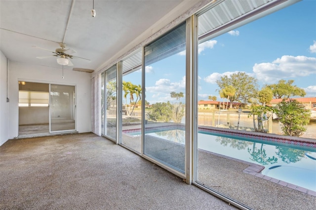 interior space with carpet flooring and ceiling fan