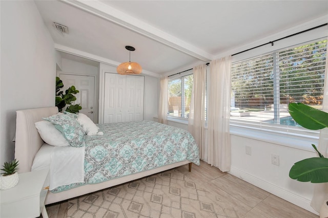 bedroom featuring vaulted ceiling with beams and a closet