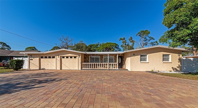 ranch-style house featuring a garage and a porch