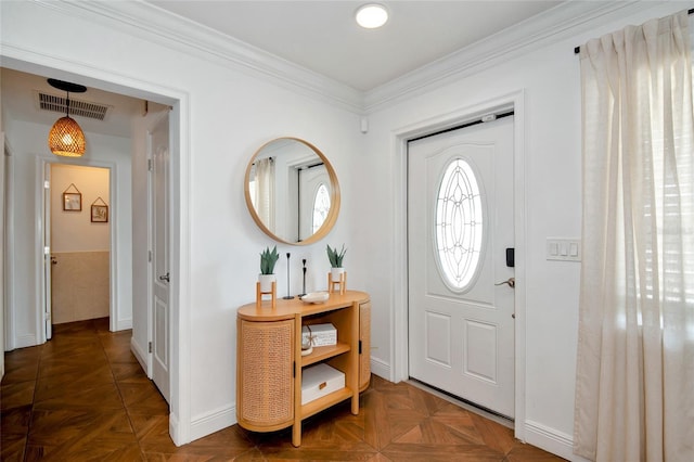 foyer entrance with dark parquet flooring and ornamental molding