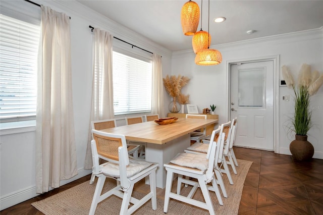 dining area with dark parquet flooring and ornamental molding