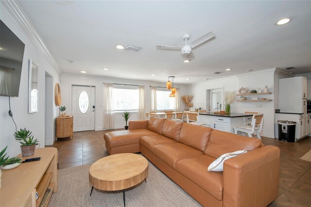 tiled living room featuring crown molding and ceiling fan