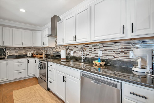 kitchen with sink, crown molding, appliances with stainless steel finishes, white cabinetry, and wall chimney exhaust hood