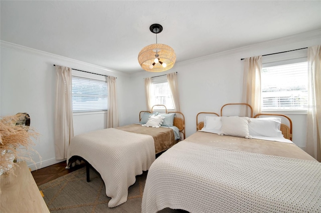 bedroom featuring crown molding and dark parquet flooring