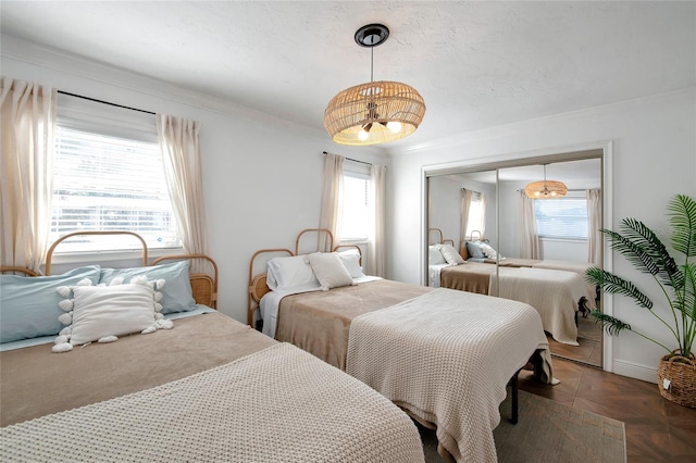 bedroom with parquet floors, ornamental molding, and a closet