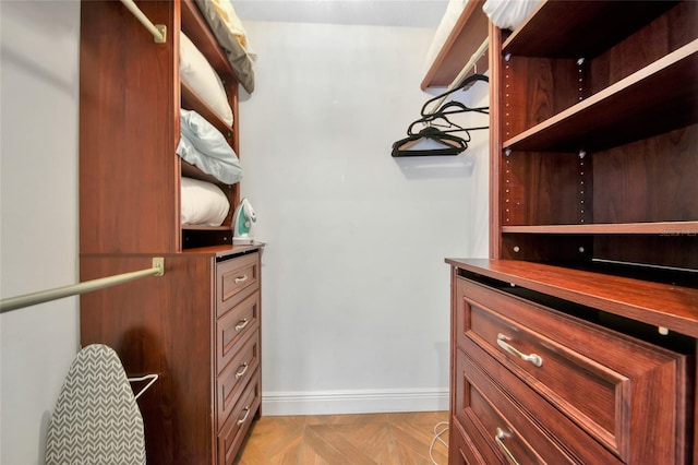 spacious closet with light parquet floors