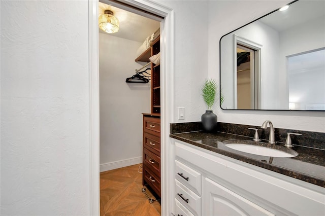 bathroom with parquet floors and vanity