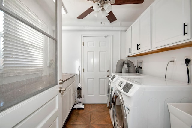 clothes washing area featuring parquet flooring, sink, cabinets, separate washer and dryer, and ceiling fan