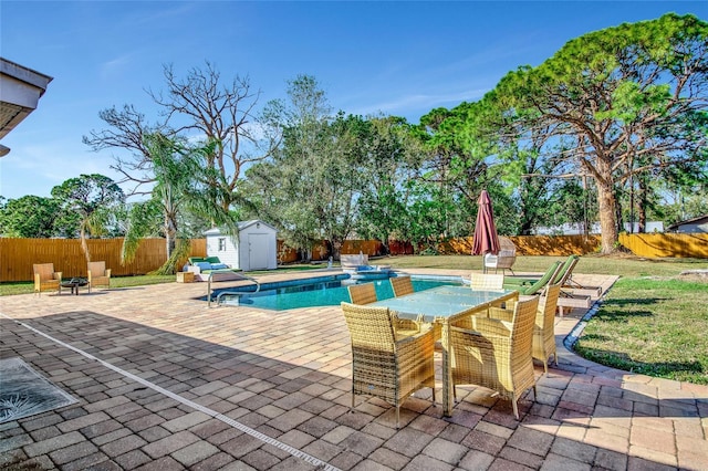 view of swimming pool featuring a patio and a storage unit