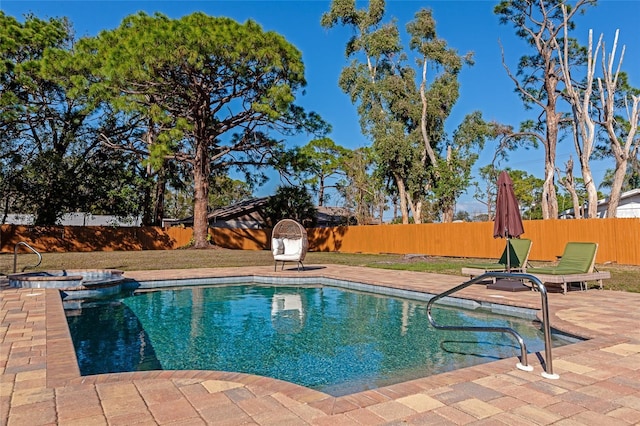 view of pool featuring an in ground hot tub and a patio area