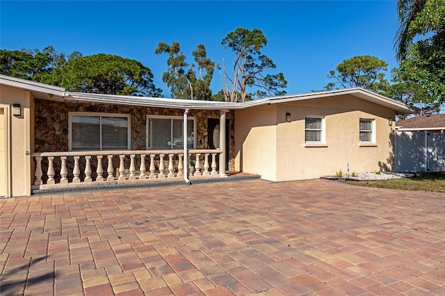 back of house featuring covered porch