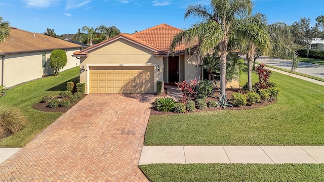 view of front of home featuring a garage and a front lawn