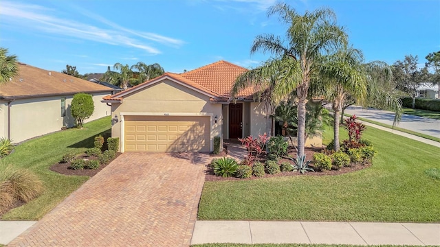 view of front of property featuring a garage and a front lawn