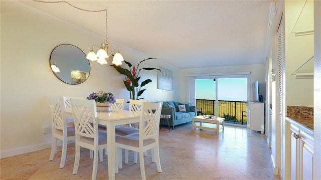 dining area featuring an inviting chandelier, light tile patterned floors, and baseboards