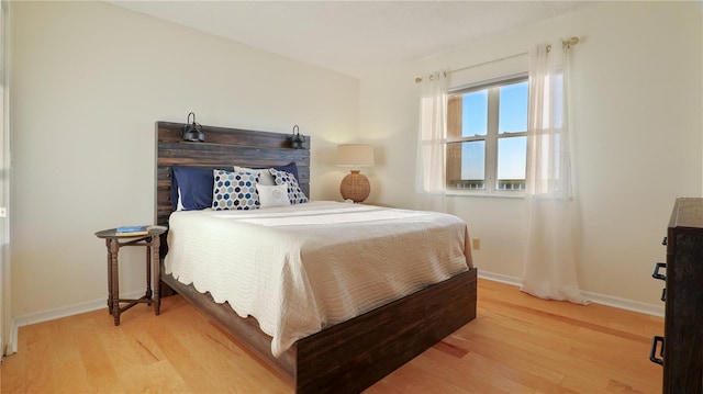 bedroom featuring light wood-type flooring and baseboards