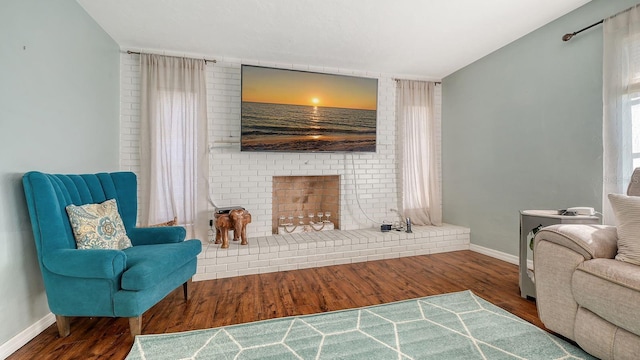 living area featuring hardwood / wood-style flooring and a fireplace