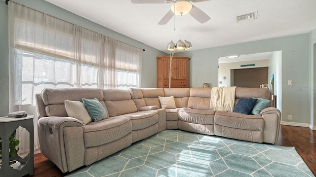 living room featuring ceiling fan and dark hardwood / wood-style flooring