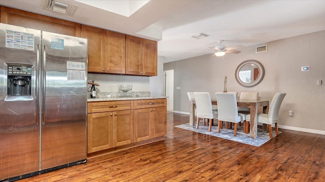 kitchen with light hardwood / wood-style flooring, light stone counters, ceiling fan, and stainless steel fridge with ice dispenser