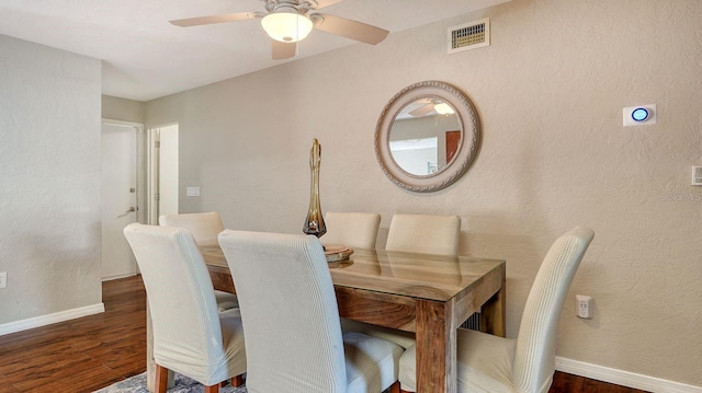 dining area with dark hardwood / wood-style floors and ceiling fan