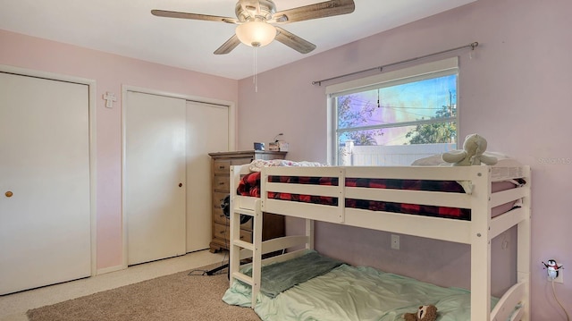 bedroom with two closets and ceiling fan