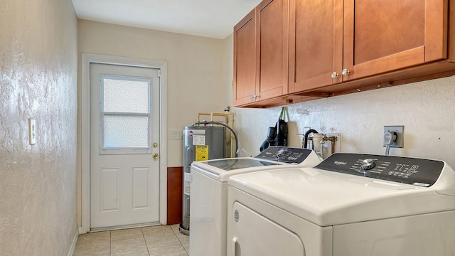 laundry area featuring light tile patterned flooring, cabinets, separate washer and dryer, and electric water heater