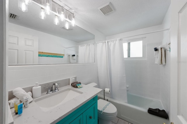 full bathroom with shower / bath combo with shower curtain, tile walls, toilet, a textured ceiling, and vanity