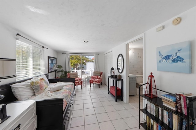 tiled living room featuring a textured ceiling