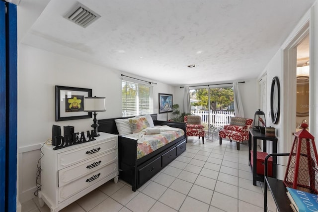 bedroom with light tile patterned floors