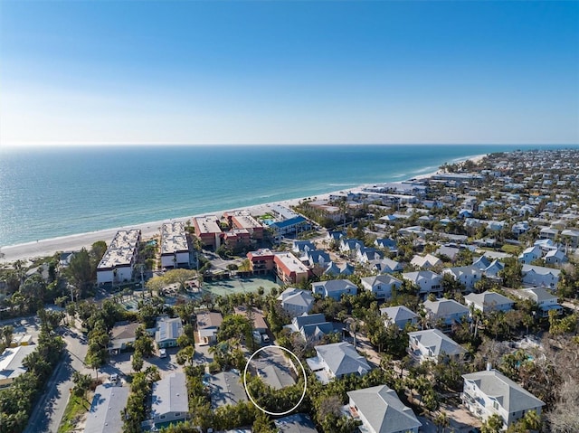 birds eye view of property with a water view and a view of the beach