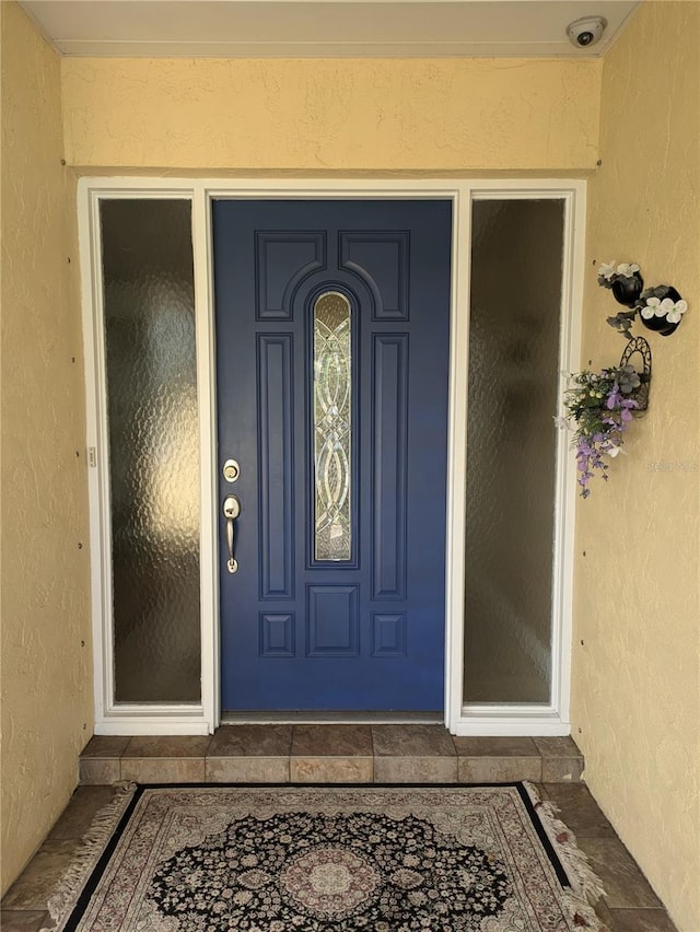 doorway to property with stucco siding