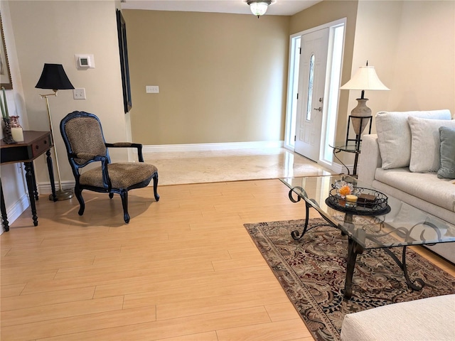 living area featuring light wood-style flooring and baseboards