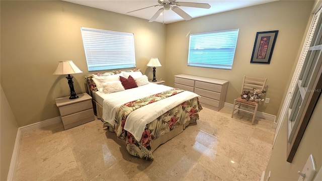 bedroom with a ceiling fan and baseboards