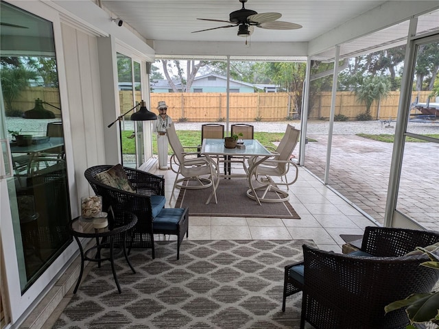 sunroom featuring ceiling fan