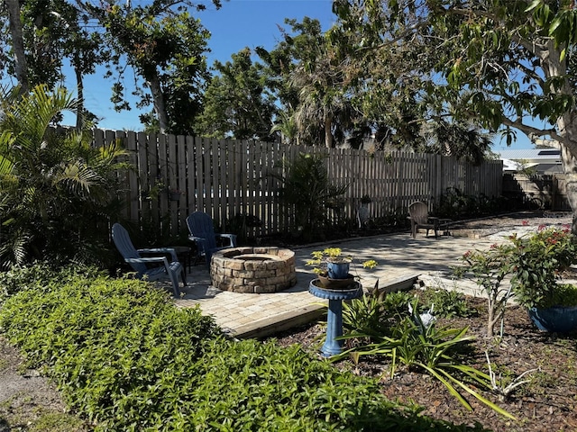 view of patio / terrace featuring a fire pit and fence