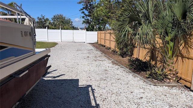 view of yard featuring a fenced backyard and a hot tub