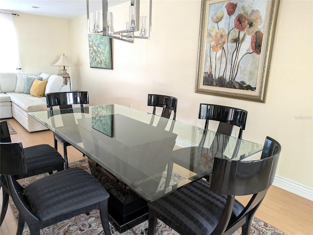 dining area featuring baseboards and wood finished floors