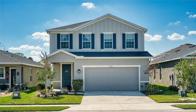 view of front property featuring a garage and a front yard